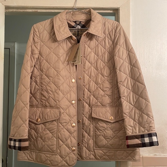 Buryberry quilts and down jacket . Size medium . Dark stone color